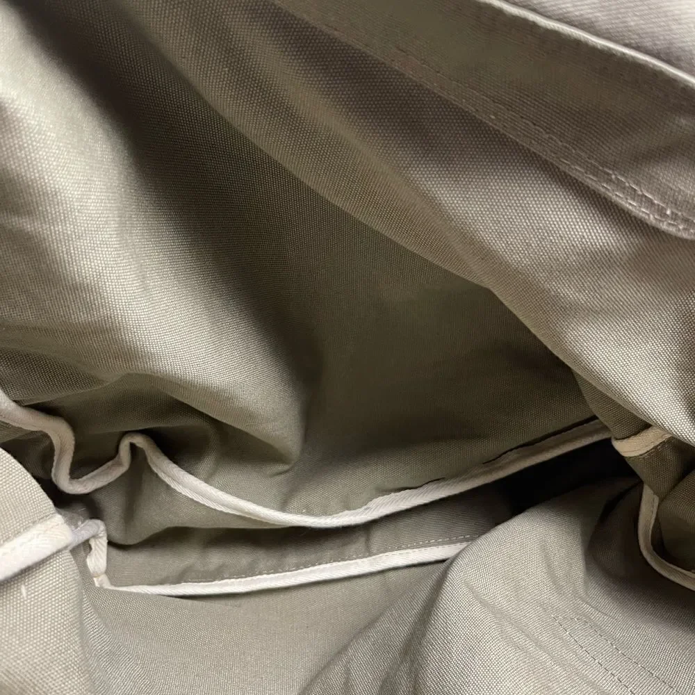 Lucky Brand large canvas olive green messenger bag with adjustable beige strap.